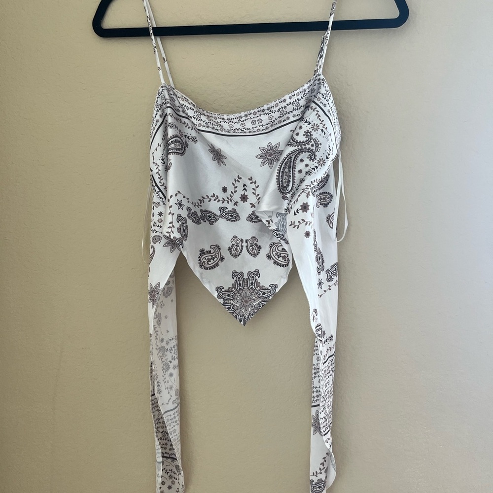 White asymmetrical camisole with scoop neck and sleeveless design